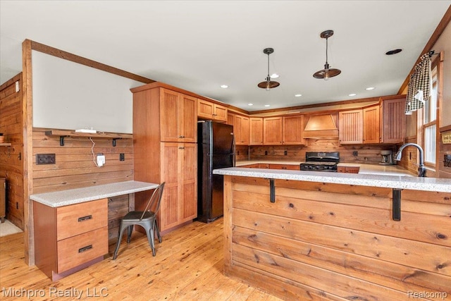 3434 Brown City Rd, Imlay City, MI 48444 - kitchen featuring black appliances, light wood-style floors, a peninsula, premium range hood, and hanging light fixtures
