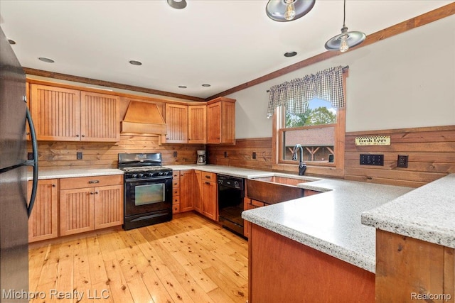 3434 Brown City Rd, Imlay City, MI 48444 - kitchen featuring black appliances, custom range hood, a sink, a wainscoted wall, and light wood finished floors