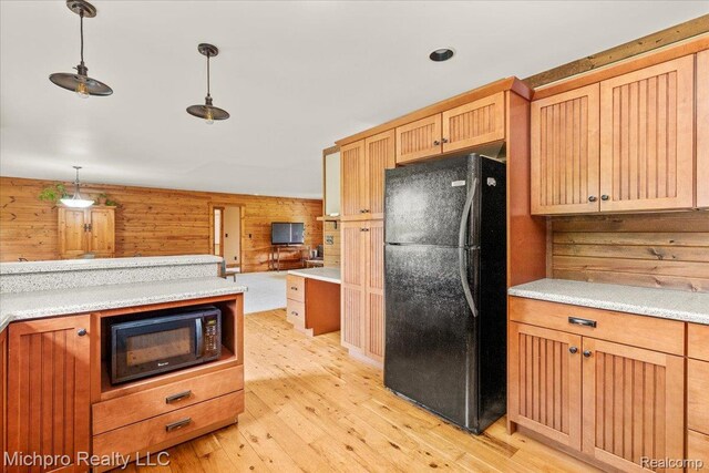 3434 Brown City Rd, Imlay City, MI 48444 - kitchen with black appliances, light wood-style floors, decorative light fixtures, and light countertops