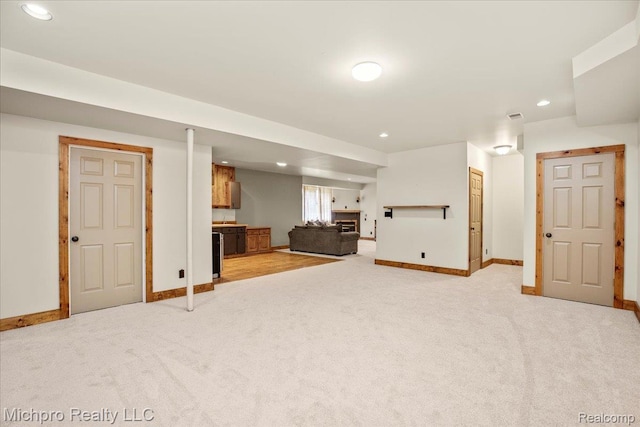 3434 Brown City Rd, Imlay City, MI 48444 - basement featuring light colored carpet, baseboards, recessed lighting, and a fireplace