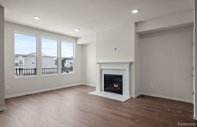 4060 Nottingham Cir, Clarkston, MI 48346 - unfurnished living room with a tiled fireplace, wood finished floors, baseboards, and recessed lighting
