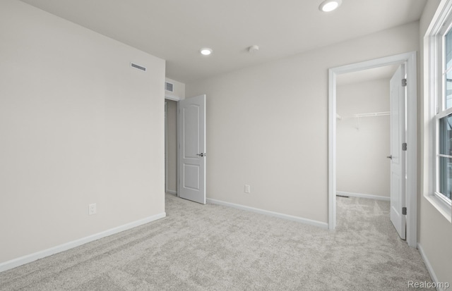 4060 Nottingham Cir, Clarkston, MI 48346 - unfurnished bedroom with carpet, a walk in closet, baseboards, recessed lighting, and a closet