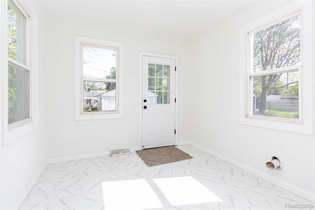 8713 Hupp Ave, Warren, MI 48089 - doorway to outside featuring marble finish flooring and baseboards
