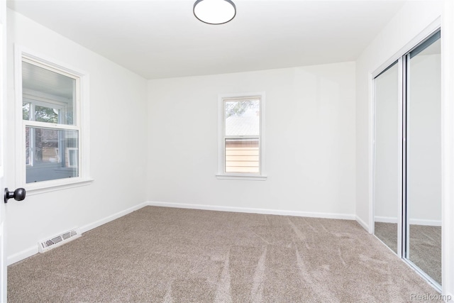 8713 Hupp Ave, Warren, MI 48089 - unfurnished bedroom with carpet flooring, a closet, and multiple windows