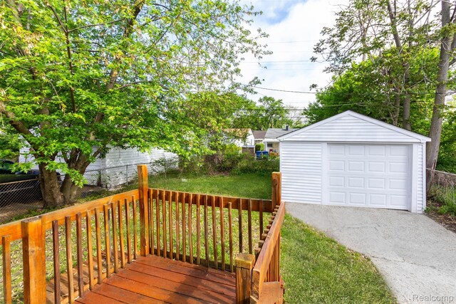8713 Hupp Ave, Warren, MI 48089 - wooden deck with driveway, an outdoor structure, and a garage