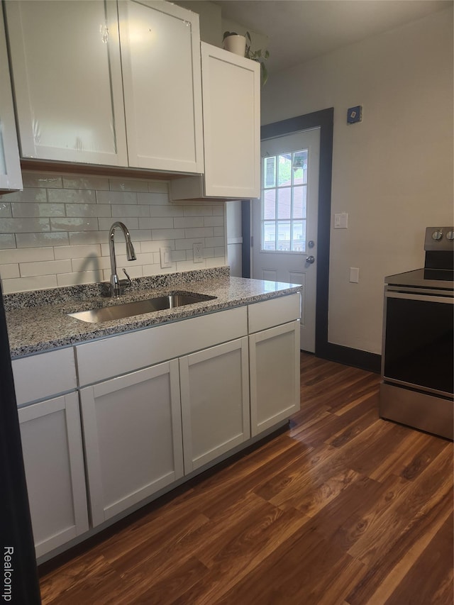 428 E Milton Ave, Hazel Park, MI 48030 - kitchen featuring electric range, a sink, backsplash, stone countertops, and dark wood finished floors