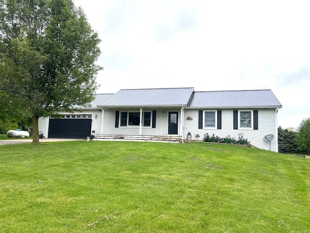 132 W Lansing Rd, Morrice, MI 48857 - ranch-style home with an attached garage, a front lawn, metal roof, and driveway