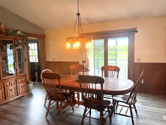 132 W Lansing Rd, Morrice, MI 48857 - dining area with a wainscoted wall, wood walls, wood-type flooring, lofted ceiling, and a chandelier