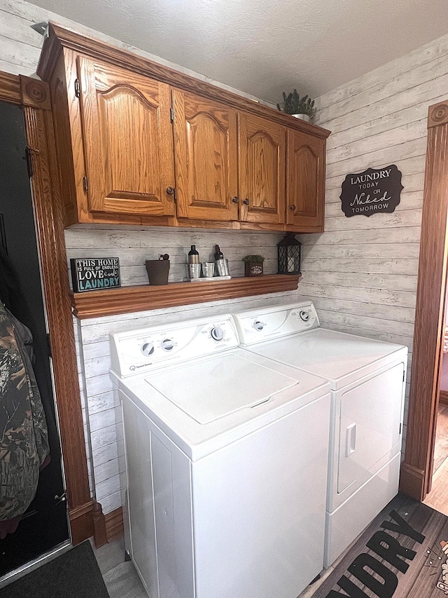 132 W Lansing Rd, Morrice, MI 48857 - washroom featuring washer and dryer, cabinet space, and wood walls