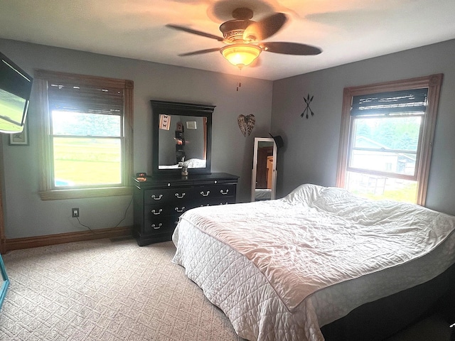 132 W Lansing Rd, Morrice, MI 48857 - bedroom featuring baseboards, a ceiling fan, and light carpet