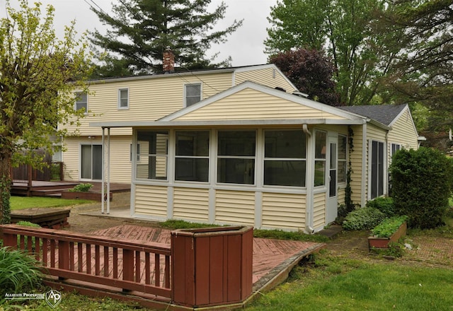 3478 N Gale Rd, Davison, MI 48423 - back of property with a sunroom, a wooden deck, and a chimney