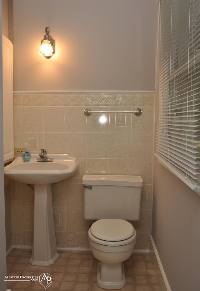 3478 N Gale Rd, Davison, MI 48423 - half bath with toilet, tile walls, a wainscoted wall, and a sink
