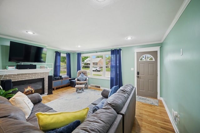 514 Granada Ave, Saint Joseph, MI 49085 - living area featuring ornamental molding, baseboards, wood finished floors, a brick fireplace, and recessed lighting