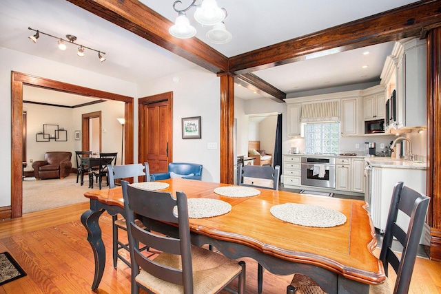 110 N O Keefe St, Cassopolis, MI 49031 - dining area with beamed ceiling, light wood-type flooring, and a chandelier