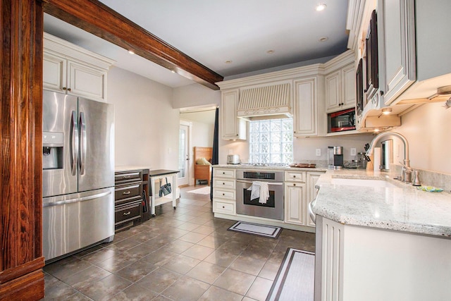 110 N O Keefe St, Cassopolis, MI 49031 - kitchen with appliances with stainless steel finishes, custom exhaust hood, dark tile patterned floors, light stone counters, and a sink