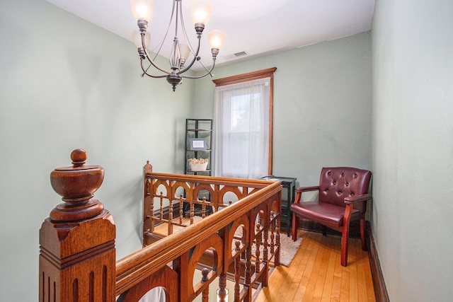 110 N O Keefe St, Cassopolis, MI 49031 - sitting room with a chandelier, light wood finished floors, baseboards, and an upstairs landing