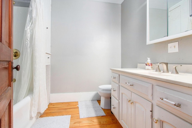 110 N O Keefe St, Cassopolis, MI 49031 - bathroom with vanity, wood finished floors, toilet, shower / bath combo, and baseboards