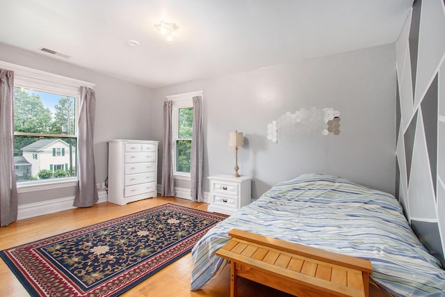 110 N O Keefe St, Cassopolis, MI 49031 - bedroom with multiple windows, light wood-style floors, and baseboards