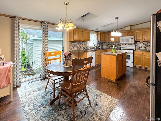 91 Sangam Pl, Swartz Creek, MI 48473 - dining area with vaulted ceiling, plenty of natural light, a chandelier, dark wood finished floors, and crown molding