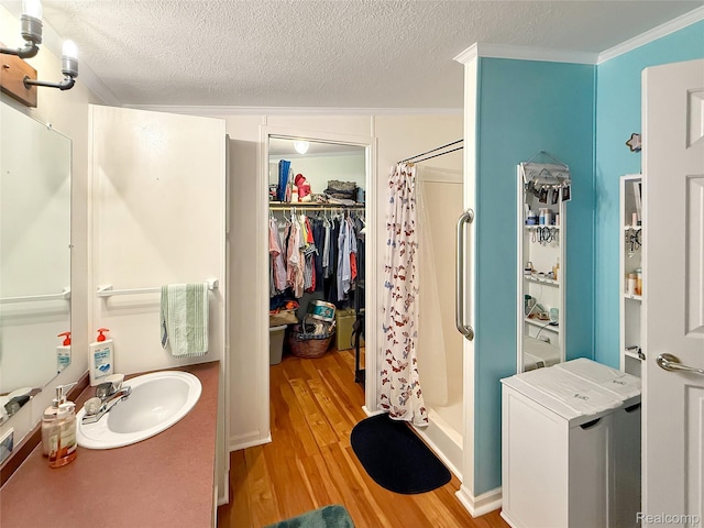 91 Sangam Pl, Swartz Creek, MI 48473 - bathroom featuring wood finished floors, a shower with shower curtain, a textured ceiling, vanity, and ornamental molding