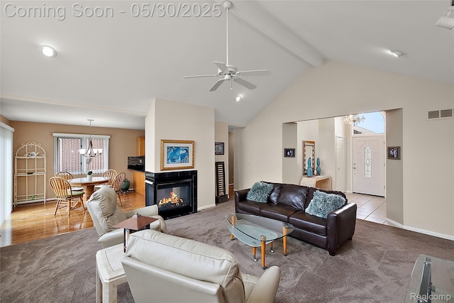 16106 Nathan Dr, Macomb, MI 48044 - carpeted living area with a chandelier, beamed ceiling, a ceiling fan, baseboards, and high vaulted ceiling
