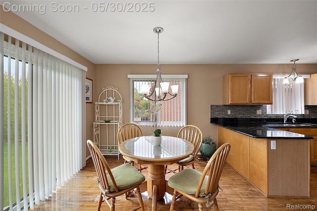 16106 Nathan Dr, Macomb, MI 48044 - dining room with a chandelier and light wood-style flooring