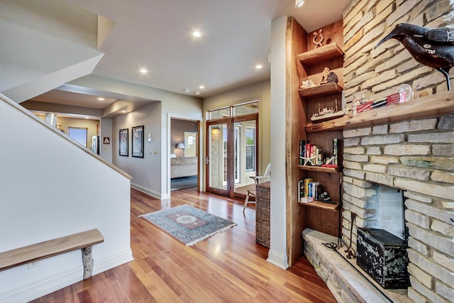 210 E Water St, New Buffalo, MI 49117 - entrance foyer with a fireplace, wood finished floors, baseboards, and recessed lighting