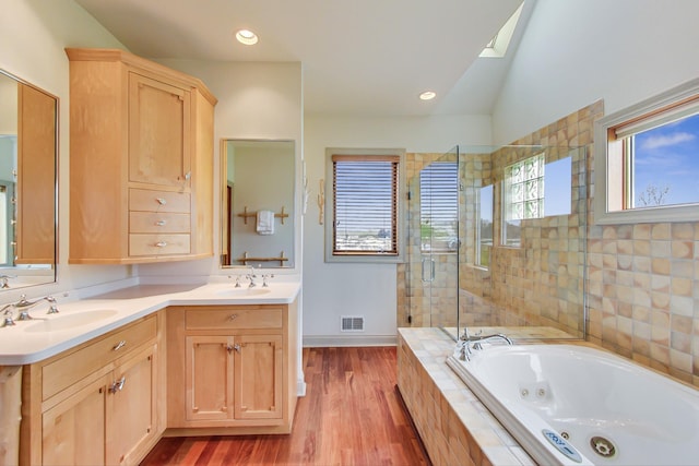 210 E Water St, New Buffalo, MI 49117 - full bath with a stall shower, a tub with jets, double vanity, wood finished floors, and vaulted ceiling