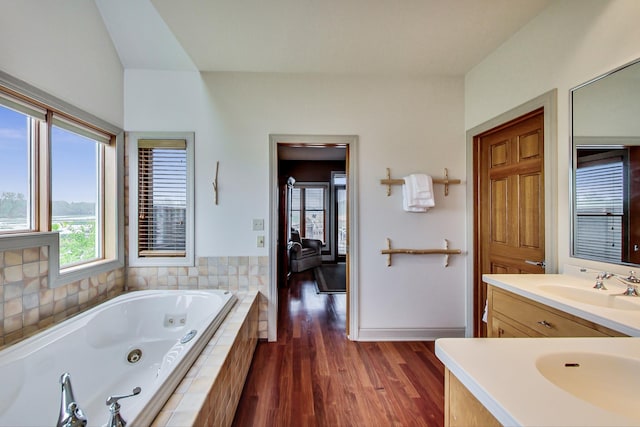 210 E Water St, New Buffalo, MI 49117 - bathroom featuring a tub with jets, vanity, and wood finished floors