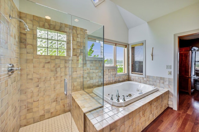210 E Water St, New Buffalo, MI 49117 - full bathroom with a stall shower, a jetted tub, wood finished floors, and vaulted ceiling