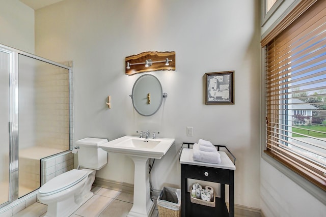 210 E Water St, New Buffalo, MI 49117 - bathroom featuring toilet, tile patterned flooring, a stall shower, and baseboards