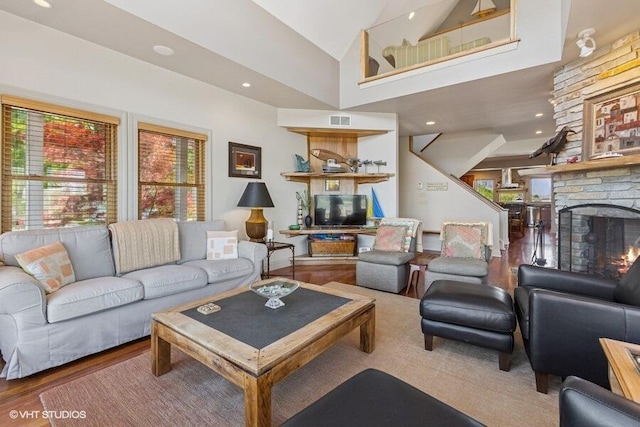210 E Water St, New Buffalo, MI 49117 - living area with wood finished floors, healthy amount of natural light, a stone fireplace, high vaulted ceiling, and recessed lighting