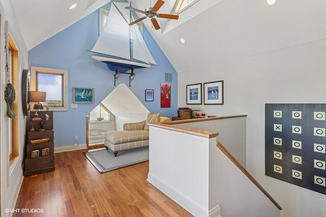 210 E Water St, New Buffalo, MI 49117 - living area with an upstairs landing, high vaulted ceiling, ceiling fan, wood finished floors, and baseboards