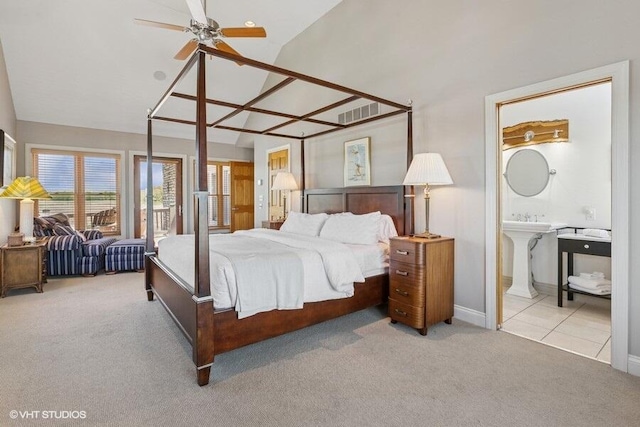 210 E Water St, New Buffalo, MI 49117 - carpeted bedroom with connected bathroom, high vaulted ceiling, and baseboards