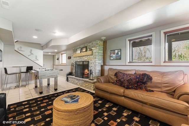 210 E Water St, New Buffalo, MI 49117 - tiled living area featuring a brick fireplace and baseboards
