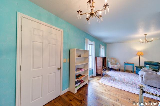 7561 Wiczer Dr, Whitehall, MI 49461 - living room with a chandelier, hardwood / wood-style floors, and baseboards