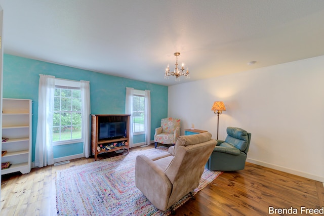 7561 Wiczer Dr, Whitehall, MI 49461 - living room featuring a chandelier, hardwood / wood-style floors, and baseboards