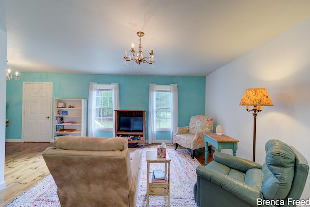 7561 Wiczer Dr, Whitehall, MI 49461 - living area featuring a chandelier, wood finished floors, and baseboards