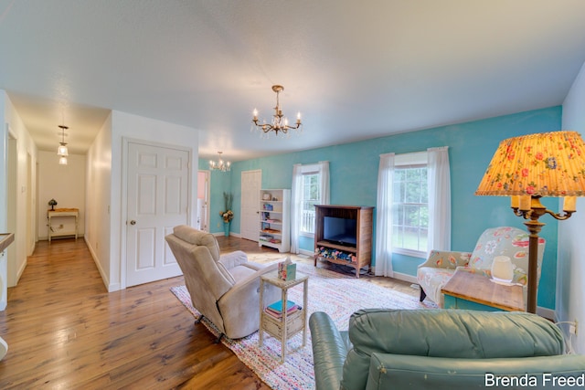 7561 Wiczer Dr, Whitehall, MI 49461 - living room with a chandelier, wood finished floors, and baseboards