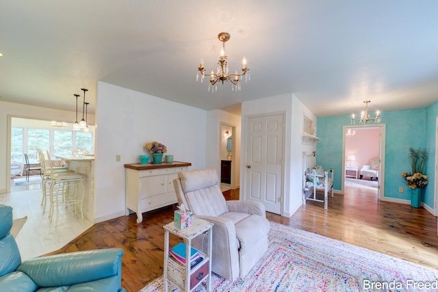7561 Wiczer Dr, Whitehall, MI 49461 - living area with a chandelier, wood finished floors, and baseboards