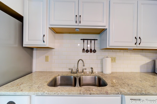 7561 Wiczer Dr, Whitehall, MI 49461 - kitchen with a sink, white cabinets, backsplash, and light stone countertops