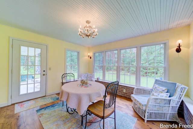 7561 Wiczer Dr, Whitehall, MI 49461 - dining room with a chandelier, hardwood / wood-style floors, and baseboards