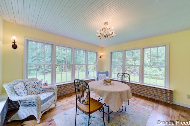 7561 Wiczer Dr, Whitehall, MI 49461 - dining space with a chandelier, wood-type flooring, and baseboards