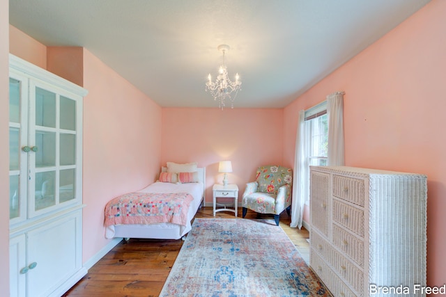 7561 Wiczer Dr, Whitehall, MI 49461 - bedroom with wood finished floors, a chandelier, and baseboards