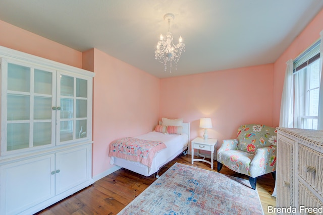 7561 Wiczer Dr, Whitehall, MI 49461 - bedroom featuring a chandelier, wood finished floors, and baseboards