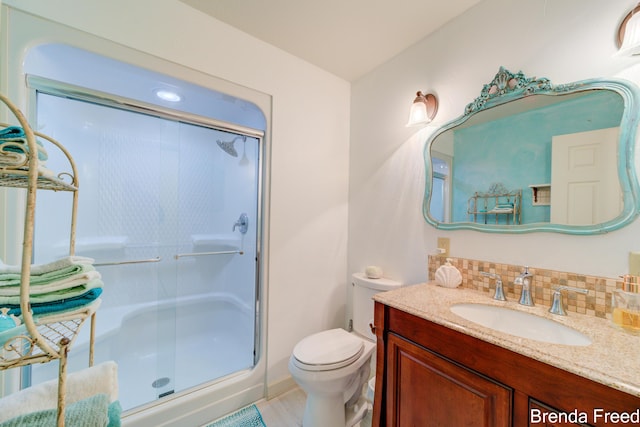 7561 Wiczer Dr, Whitehall, MI 49461 - full bathroom with a stall shower, vanity, toilet, and tasteful backsplash