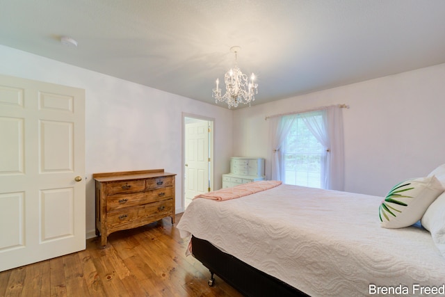 7561 Wiczer Dr, Whitehall, MI 49461 - bedroom with a chandelier and wood finished floors