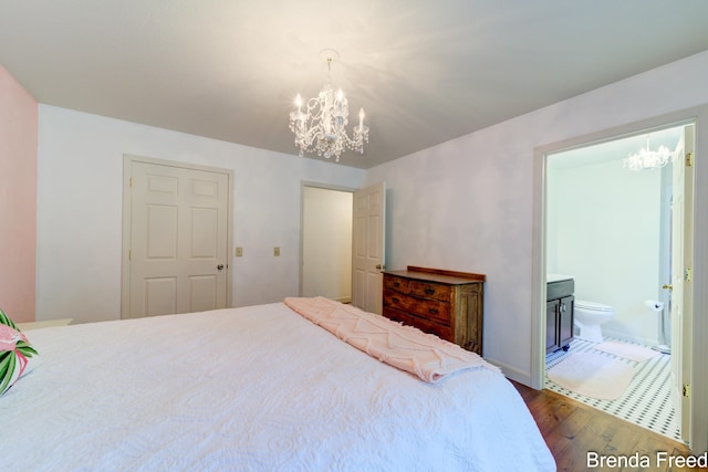 7561 Wiczer Dr, Whitehall, MI 49461 - bedroom with a chandelier, wood-type flooring, and connected bathroom
