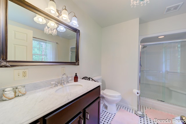 7561 Wiczer Dr, Whitehall, MI 49461 - bathroom featuring a chandelier, vanity, a shower stall, toilet, and tile patterned floors
