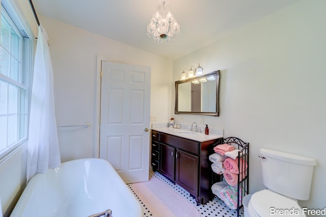 7561 Wiczer Dr, Whitehall, MI 49461 - bathroom featuring a bath, a chandelier, vanity, and toilet